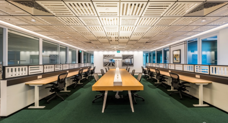Modern open office with sleek furniture, ergonomic chairs, and a clean design.