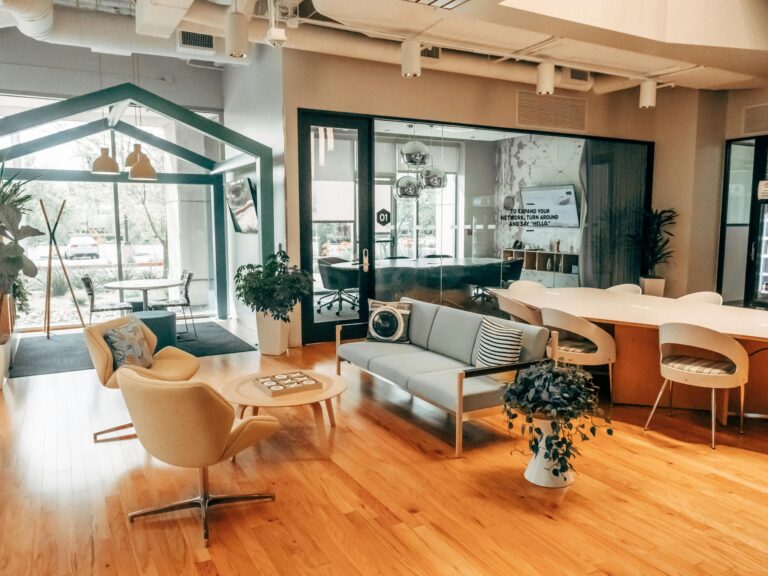 Modern coworking lounge with cozy seating, natural light, and stylish decor in an open, airy layout.